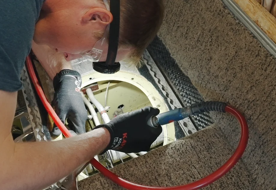 Technician inspecting a wheel well