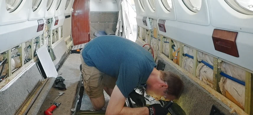 Technician working inside a King Air cabin