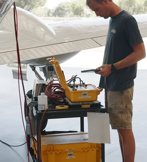 Technician with a test set beside a King Air