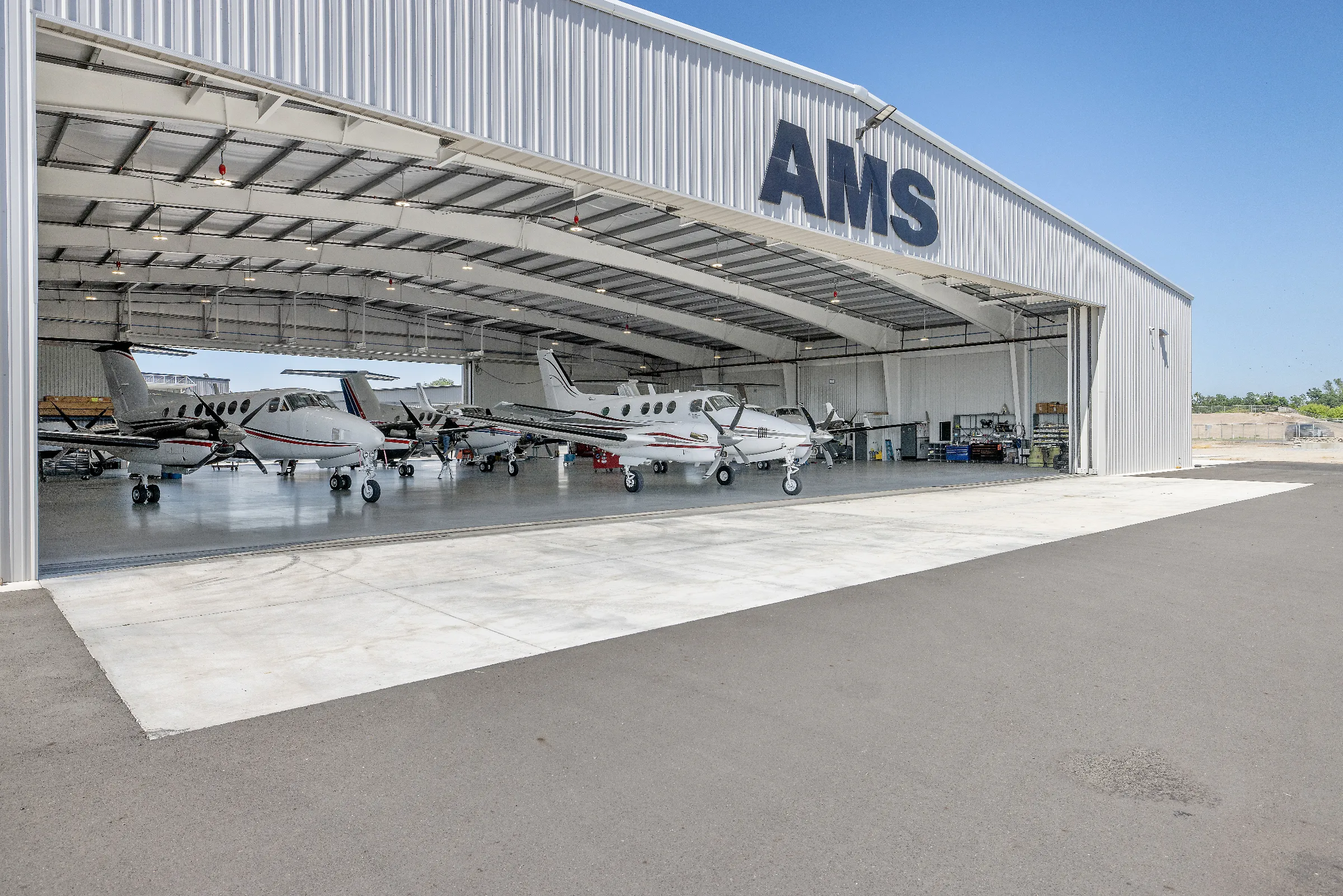 AMS hangar doors open with aircraft inside