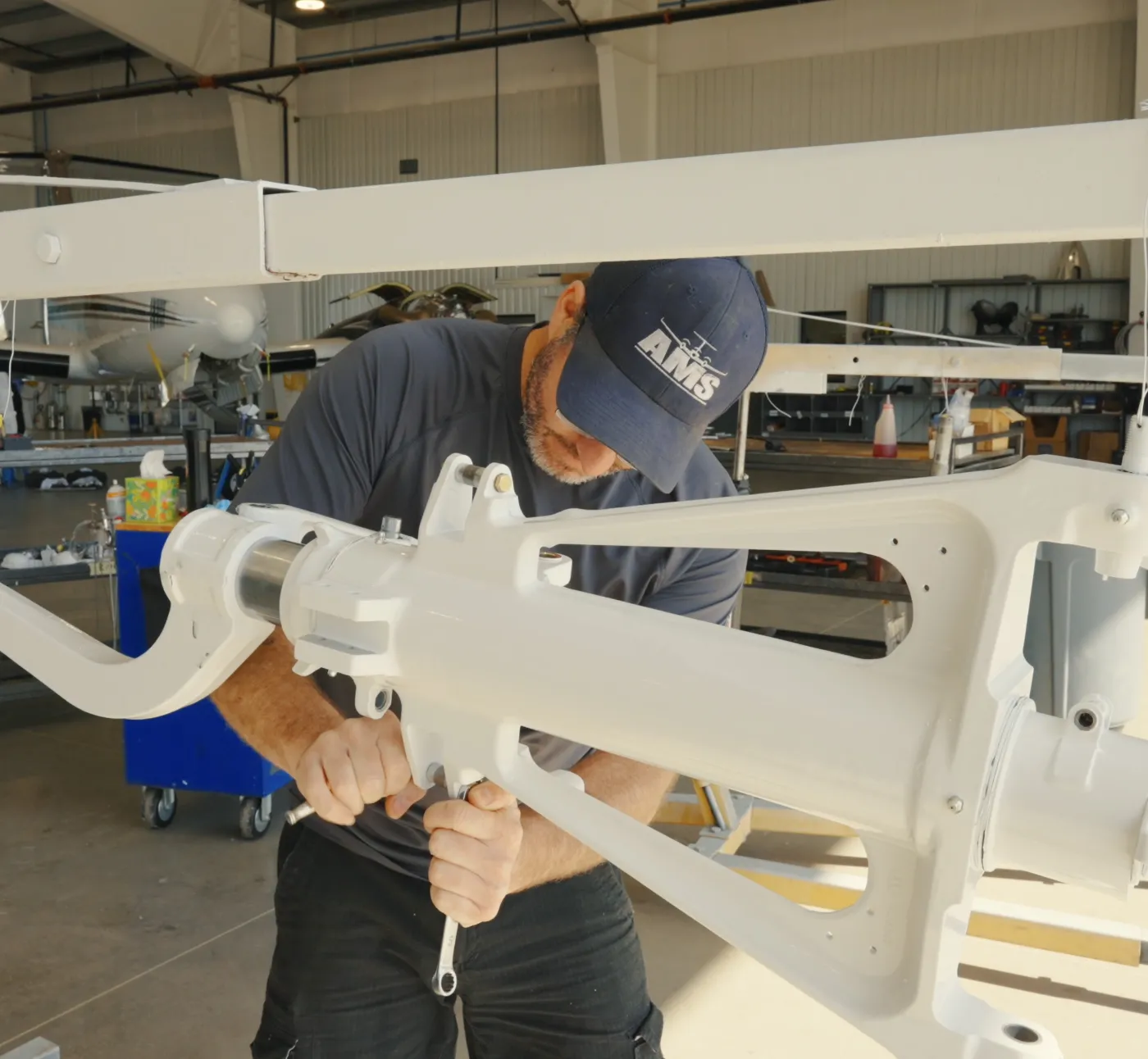 AMS technician overhauling King Air landing gear