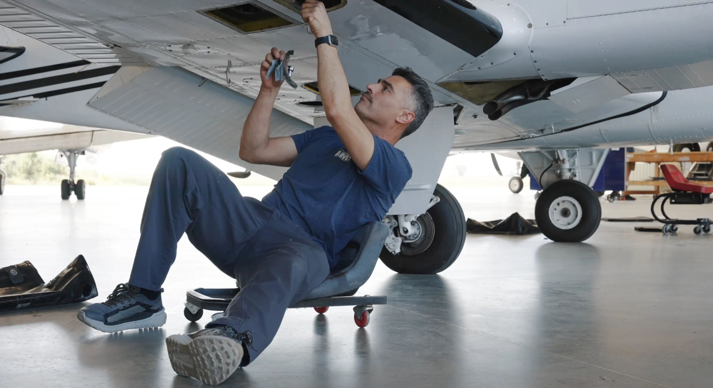 Technician inspecting a wing underside